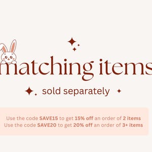 Op de afbeelding: Afbeelding met de tekst "matching items" in donkerrood script, met een kleine konijnenillustratie. De tekst "sold separately" staat eronder. De afbeelding bevat ook een lichtroze rechthoek met tekst.