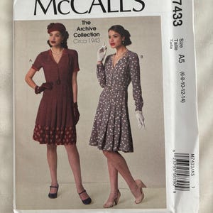 May include: McCall's sewing pattern M7433 featuring two vintage dresses from the Archive Collection, circa 1943. The pattern includes sizes A5 (6-8-10-12-14). The cover displays illustrations of the dresses, with the McCall's logo at the top.