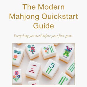 May include: A book cover titled "The Modern Mahjong Quickstart Guide" with the text "Everything you need before your first game." The image displays white mahjong tiles with various illustrations and numbers.