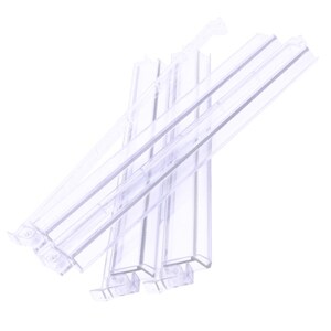 May include: A collection of clear, rectangular plastic shelf dividers. The dividers are transparent and have a series of parallel lines running along their length. The dividers are angled and slightly overlapping, creating a layered effect.
