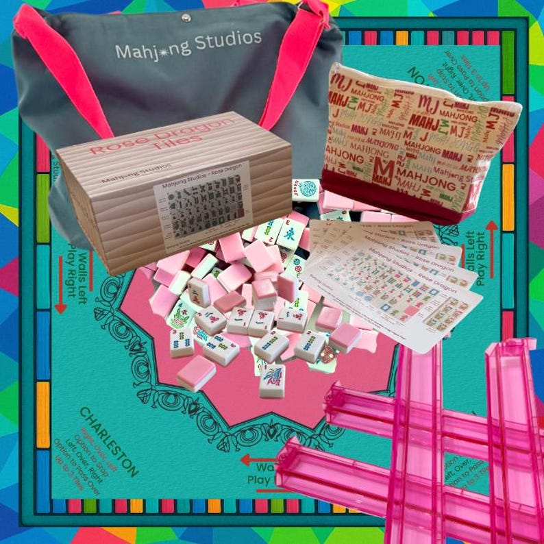May include: A Mahjong set with pink tiles, a wooden box labeled "Rose Dragon Files," and a gray bag with pink straps. The set includes a game board and accessories. The text "Mahjong Studios" is visible.