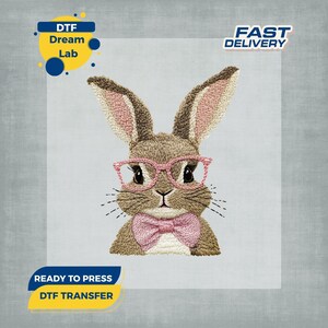 May include: Embroidered bunny wearing pink glasses and a bow tie. The bunny is brown with pink inner ears and a pink bow tie. The image includes the text "DTF Dream Lab", "Fast Delivery", and "Ready to Press DTF Transfer".