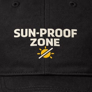 May include: Black baseball cap with the text "SUN-PROOF ZONE" in white, above a yellow sun symbol with a line through it. The cap is made of a durable fabric and has a curved brim.