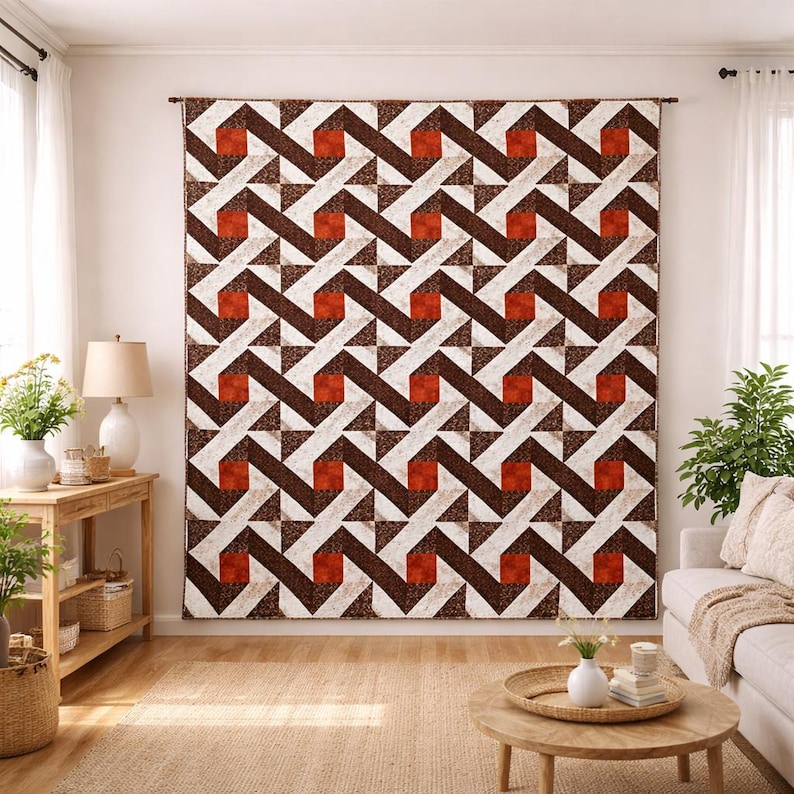 May include: Large wall hanging with a geometric pattern in shades of brown, white, and rust. The design features repeating zig-zag lines and square and triangular shapes. The textile is displayed in a living room setting.