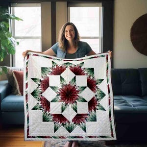 May include: A white quilt with a geometric floral design in shades of red, green, and white. The quilt features a central starburst pattern with alternating squares and triangles. The quilt is approximately 60 inches by 60 inches.