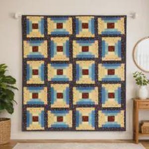 May include: A rectangular quilt featuring a repeating log cabin block pattern. The design consists of a central dark brown square surrounded by concentric layers of light cream, medium blue, and a dark navy blue fabric with small white dots.