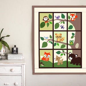 May include: A framed woodland-themed art print featuring nine square panels. Each panel showcases a different forest animal, including an owl, fox, raccoon, and bear, set against a backdrop of trees and leaves. The color palette includes greens, browns, and oranges.