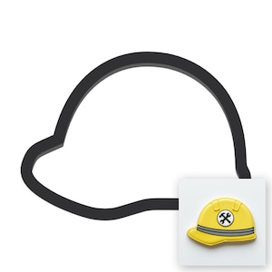 May include: A black outline of a hard hat shape paired with a small square tile featuring a yellow hard hat icon with a grey band and a circular emblem containing crossed wrenches in the center, set against a plain white background.