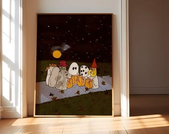 May include: A framed rectangular wall art print featuring a cartoon illustration of five figures in Halloween costumes, including ghosts and a witch, walking on a sidewalk at night under a yellow moon and starry sky, holding orange trick-or-treat bags.