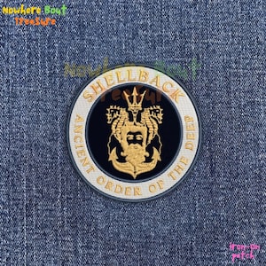 May include: A white ceramic mug with a black handle and the text "But First, Coffee" in a bold, black font. The mug is set against a blurred background, suggesting a cozy setting.