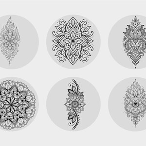 May include: Six black and white mandala designs on grey circular backgrounds. The mandalas feature intricate floral and geometric patterns, including lotus flowers and symmetrical arrangements. The designs are suitable for tattoos or decorative art.