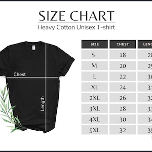 May include: A black heavy cotton unisex t-shirt with a size chart. The chart lists chest and length measurements in inches for sizes S through 5XL. The shirt has a crew neck and short sleeves. A sprig of greenery is on the left side.