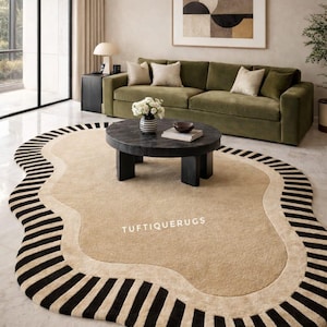 May include: A beige and black patterned rug with an irregular shape. The rug has a light beige central area, bordered by a black and beige striped design. The text "TUFTIQUERUGS" is visible on the rug.