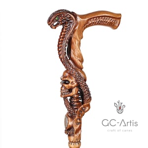 Cane displayed on white background, emphasizing contrast and depth of carved snake and skull details. Smooth finish and ergonomic handle ensure comfort and stability.