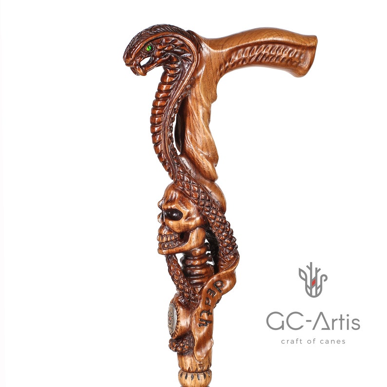 Cane displayed on white background, emphasizing contrast and depth of carved snake and skull details. Smooth finish and ergonomic handle ensure comfort and stability.