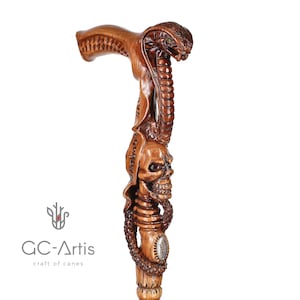 Side view of snake-skull cane photographed on white backdrop. The ergonomic wooden handle flows into detailed snake pattern. GC-Artis walking cane represents precision craftsmanship and unique gothic-inspired design.