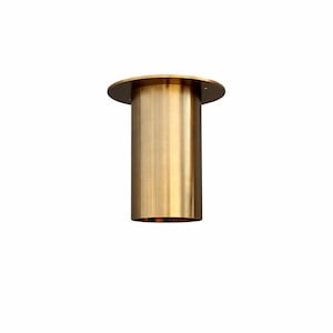 May include: A cylindrical brass furniture leg with a circular top and a smooth, polished finish. The leg is designed to be mounted on a surface and provides support. The brass colour gives it a modern and elegant look.