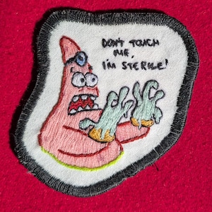 May include: Embroidered patch featuring Patrick Star from Spongebob Squarepants. The pink starfish character is depicted with a panicked expression and gloved hands. Text reads "DON'T TOUCH ME, I'M STERILE!" The patch has a white background with a black border, set against a red backdrop.