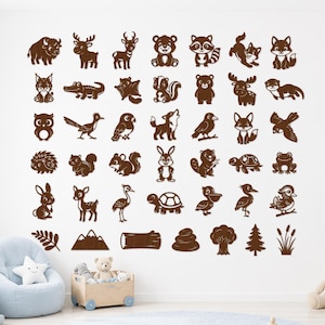 May include: A collection of brown wall decals featuring various woodland animals, birds, reptiles, and nature elements arranged in a grid. The set includes illustrations of a bison, deer, bear, raccoon, fox, owl, rabbit, turtle, frog, and trees.
