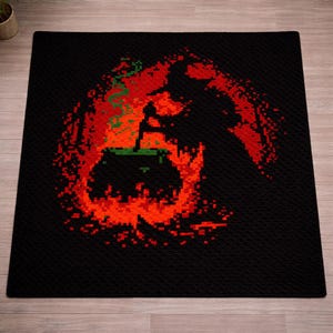 May include: A square black rug featuring a pixel art design of a silhouette stirring a cauldron. The cauldron is surrounded by vibrant orange and red flames, with a green substance bubbling over the top edge in a pixelated style.
