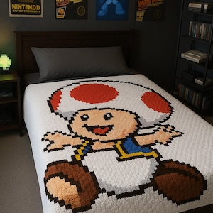 May include: A white pixelated blanket featuring the character Toad from the Mario Bros. video game series. The blanket has a large red and white mushroom cap design, with Toad's face and body in the center. The blanket is on a bed with video game posters in the background.