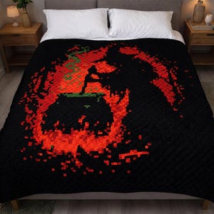May include: A black blanket featuring a pixelated graphic of a cauldron surrounded by vibrant red flames and green smoke. The design is centered on the fabric, creating a stark contrast against the solid black background of the textile.