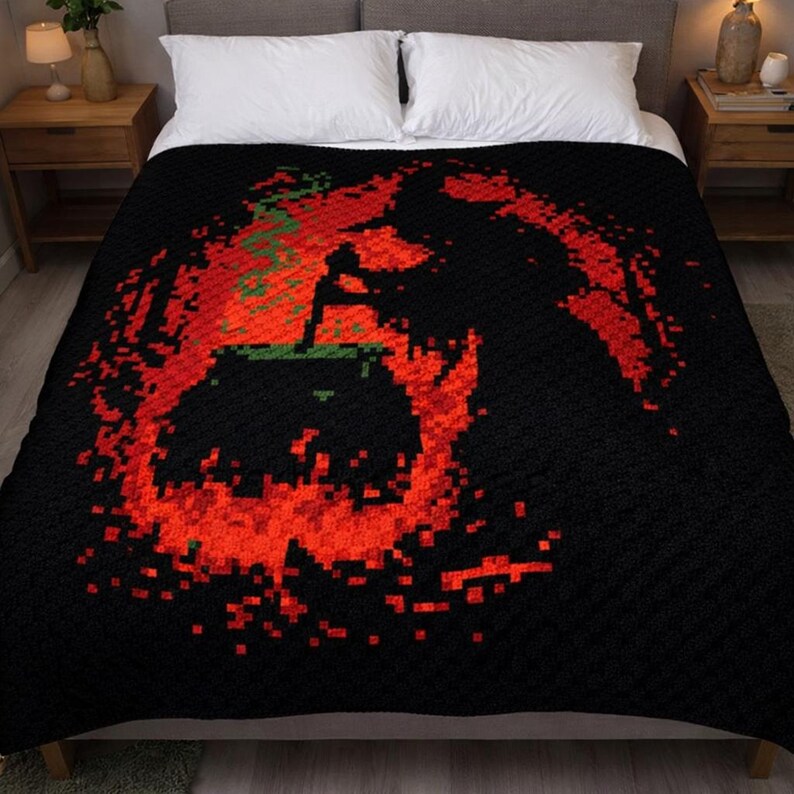 May include: A black blanket featuring a pixelated graphic of a cauldron surrounded by vibrant red flames and green smoke. The design is centered on the fabric, creating a stark contrast against the solid black background of the textile.