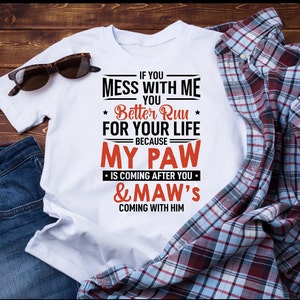 May include: White t-shirt with a black and red graphic that says "If you mess with me you better run for your life because my paw is coming after you & maw's coming with him".