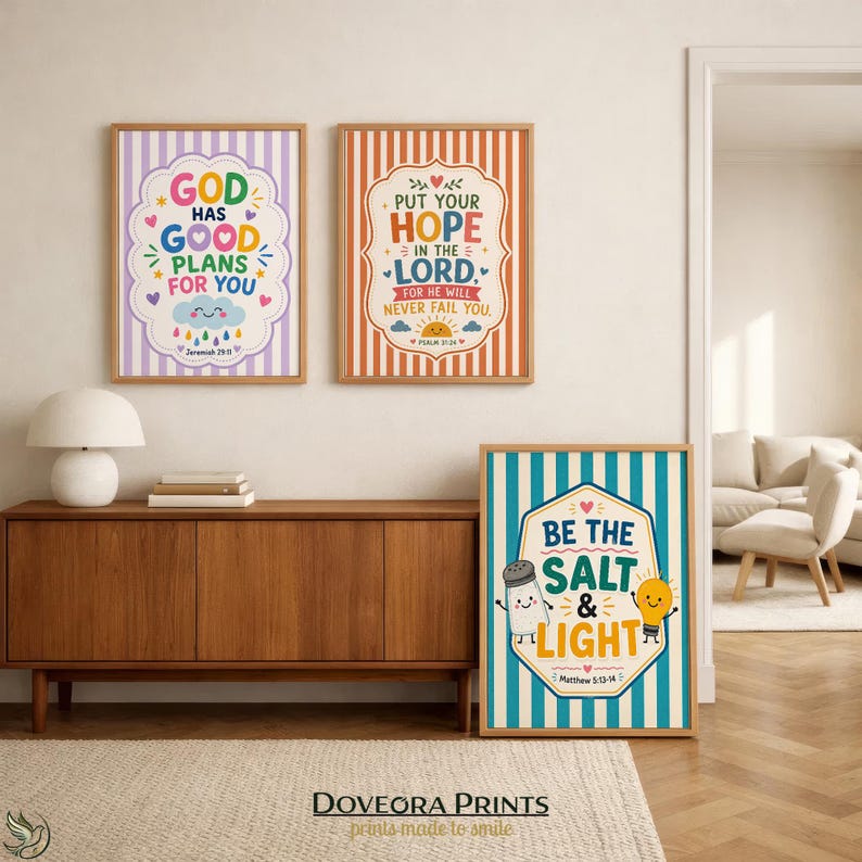 Three framed prints with Christian sayings and playful illustrations hang on a wall.