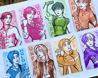 May include: Eight rectangular art cards with illustrations of people in various poses. Each card has a unique colour palette and text, such as "NAY," "YOUTH," "ULTRA," "SO GOOD," "HOLD MY HAND," "UNFAIR," and "AS WE ARE."