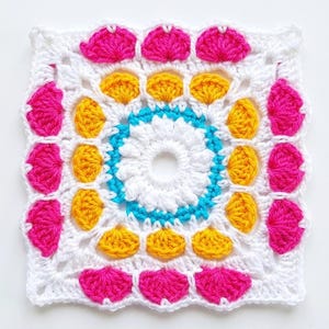 May include: A square crochet motif featuring a central white ring, a bright turquoise circular border, and concentric layers of yellow and hot pink fan-shaped stitches. The entire piece is framed by white yarn in a square shape.