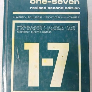 May include: A teal book cover with the title "electricity one-seven" in white. The text "revised second edition" and the name "HARRY MILEAF" are also visible. A large white "1-7" is the central design element, suggesting a textbook on electrical engineering.
