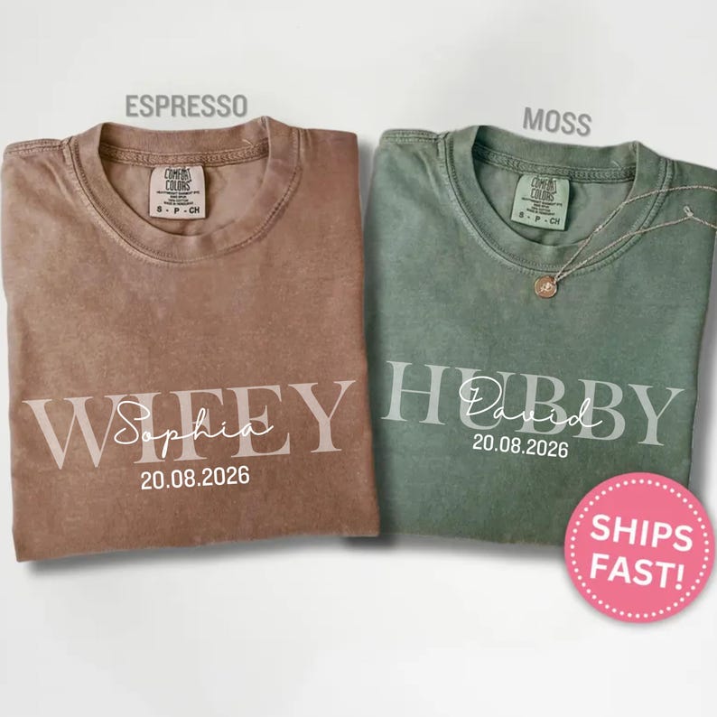 May include: Two t-shirts, one espresso-colored and one moss-colored, are displayed. The espresso shirt says "Wifey Sophia 20.08.2026" and the moss shirt says "Hubby David 20.08.2026". A pink sticker with "SHIPS FAST!" is visible.
