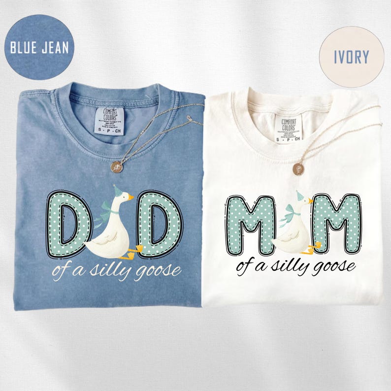 May include: Two t-shirts, one blue jean and one ivory, with the text "DAD of a silly goose" and "MOM of a silly goose". Each shirt features a goose graphic and a necklace.