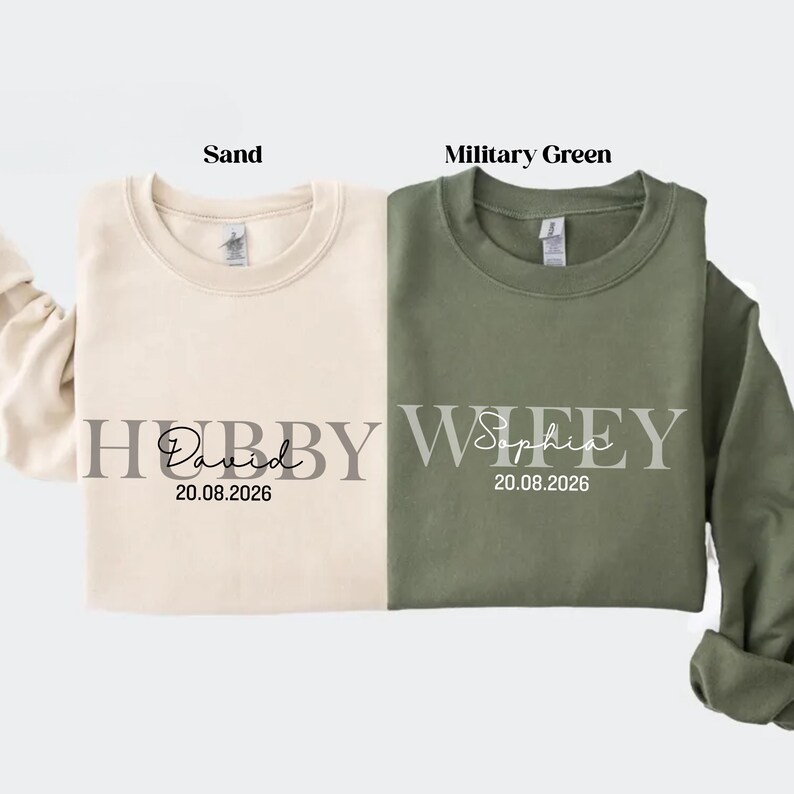 May include: Two crewneck sweatshirts, one sand-colored and one military green. The sand sweatshirt says "Hubby David 20.08.2026" and the green sweatshirt says "Wifey Sophia 20.08.2026".
