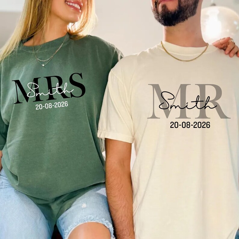 May include: Two matching shirts, one green and one cream, with the text "MRS Smith 20-08-2026" and "MR Smith 20-08-2026" printed on the front. The green shirt is long-sleeved, and the cream shirt is short-sleeved. Both shirts are casual and suitable for a couple.