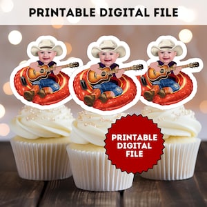 May include: Three cupcakes topped with white frosting and pearl sprinkles. Each cupcake has a decorative topper featuring a baby in a cowboy hat playing a guitar. The image includes the text "PRINTABLE DIGITAL FILE".