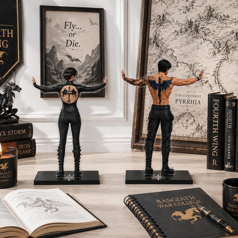 May include: Two acrylic character standees featuring a person in a black bodysuit with a dragon tattoo and a shirtless person with a large back tattoo, both standing with arms outstretched on black rectangular bases with compass rose designs.