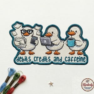 May include: Embroidered patch featuring three cartoon ducks. One duck wears glasses and holds papers and a calculator. Another uses a laptop, and the third holds a coffee cup. The text "debits credits and caffeine" is below.