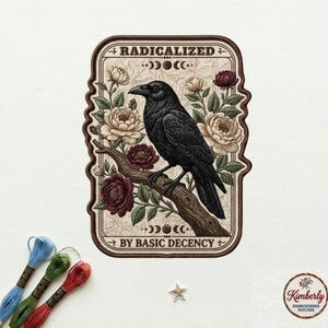 May include: Embroidered patch featuring a black raven perched on a branch, surrounded by cream and burgundy flowers. The patch has the text "RADICALIZED" and "BY BASIC DECENCY". The patch is a rectangle with a decorative border.