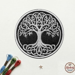 May include: Embroidered patch featuring a white Celtic Tree of Life design on a black circular background. The patch has a white border and is surrounded by embroidery floss in blue, green, and red. The patch is on a white surface.