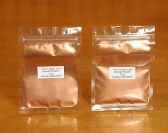 May include: Two clear plastic pouches filled with fine copper leaf bronze powder. Each pouch has a white label with black text indicating the product name, weight (5 gr and 15 gr), and the seller's name.