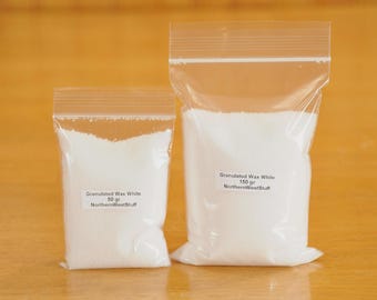 May include: Two clear plastic bags filled with white granulated wax. The smaller bag is labeled "Granulated Wax White 50 gr NorthernWestStuff". The larger bag is labeled "Granulated Wax White 150 gr NorthernWestStuff". The bags are sealed with a zip closure.