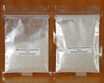 May include: Two clear plastic bags filled with white, glittery powder. Each bag has a white label with black text that reads "Mega Sparkle Coated Mica" and "NorthernWestStuff". One bag contains 10 grams, the other 25 grams.