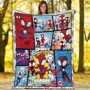 May include: A colorful Marvel Spidey and His Amazing Friends blanket. The blanket features a comic book style design with various Spiderman characters in action poses. The blanket has a blue border and the text "NAME" is visible.