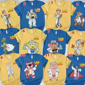 May include: A collection of twelve short-sleeved t-shirts in yellow and blue. Each shirt features a different cartoon character from the "Toy Story" franchise, dressed in a lab coat, with the words "LAB STORY" printed above the character.