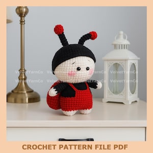 May include: A handmade crochet ladybug doll with a black hat and red overalls. The doll has a white face with rosy cheeks and black eyes. The text "CROCHET PATTERN FILE PDF" is at the bottom of the image.