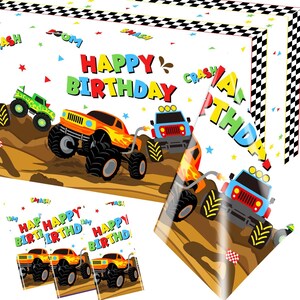 May include: A rectangular birthday banner and matching cards featuring a monster truck theme. The design includes orange and blue trucks on a brown dirt track, a black and white checkered border, and the text HAPPY BIRTHDAY with comic-style words.
