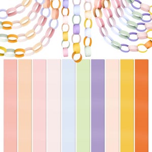 May include: Paper chain garlands in pastel colors, including pink, peach, lavender, and yellow. Vertical strips of matching colors are arranged below the garlands. The paper chains are made of interlocking paper rings.