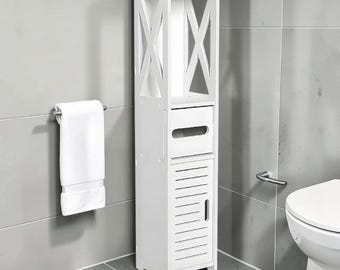 May include: A tall, white bathroom storage cabinet with an open top shelf, a drawer, and a cabinet door with horizontal slats. The cabinet has an X-shaped design on the sides. A white towel hangs on a chrome towel bar.